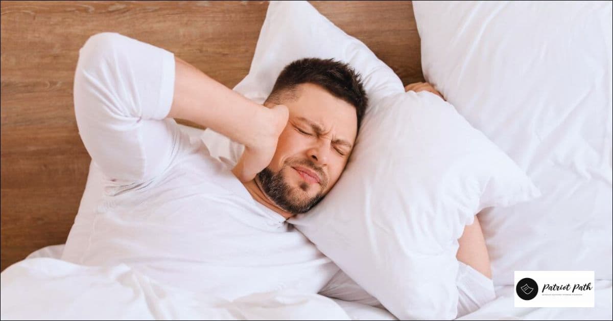 Tinnitus VA nexus letter - Patriot Path physician review A man in bed covers one ear against constant ringing, the kind of tinnitus a VA nexus letter connects to military noise exposure.